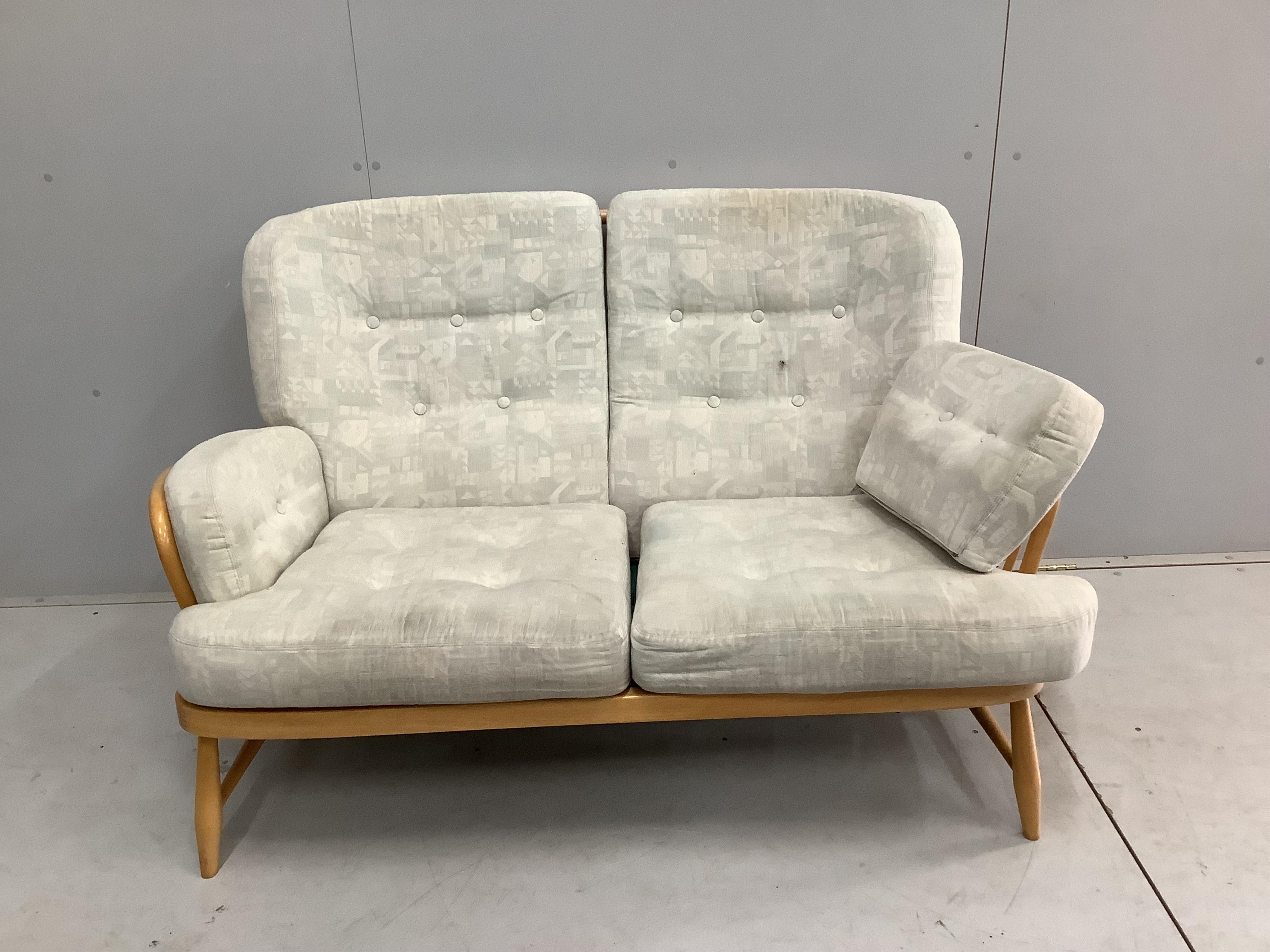 A pair of Ercol beech settees, width 140cm, depth 80cm, height 82cm